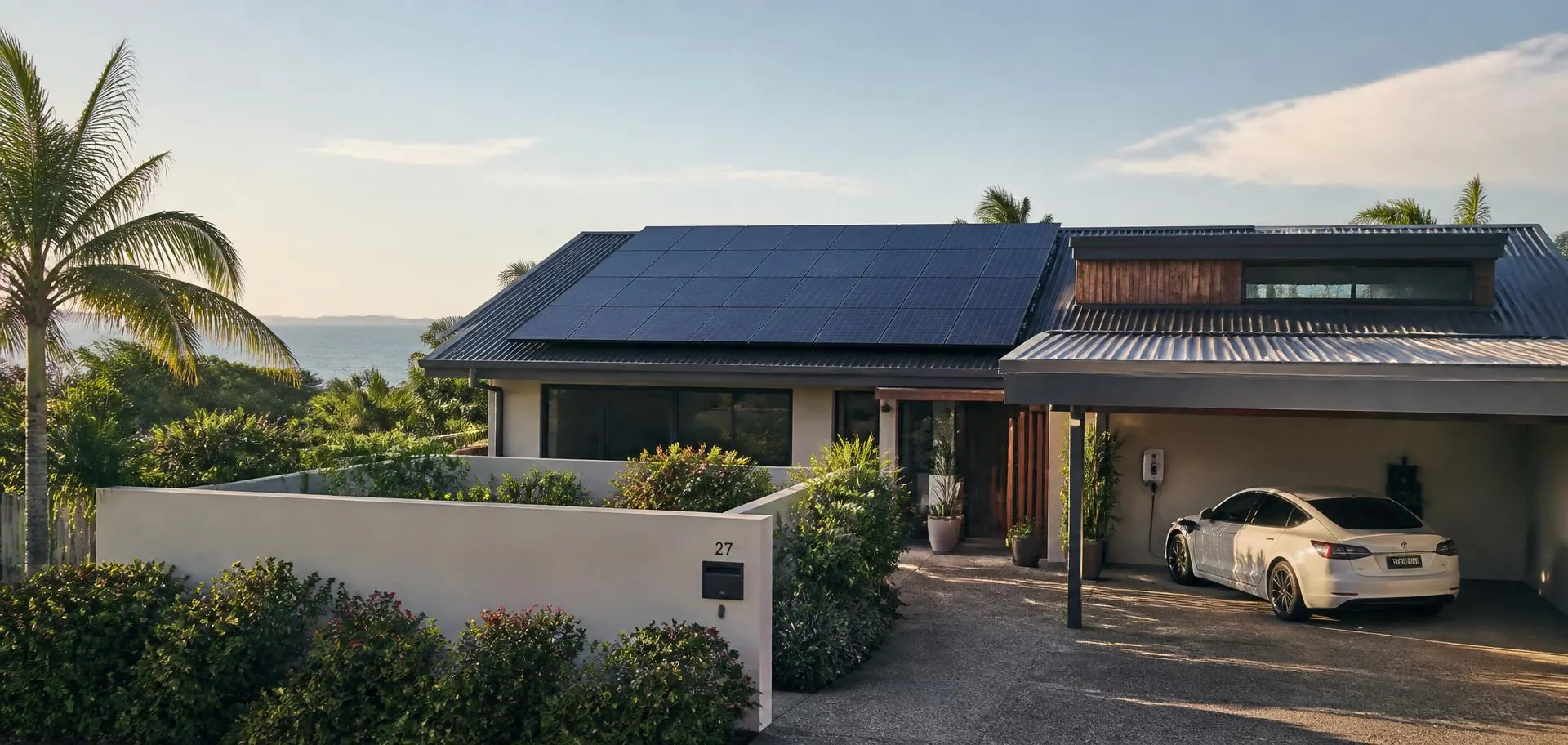 Queensland home with rooftop solar panels and an electric car charging in the carport in afternoon light
